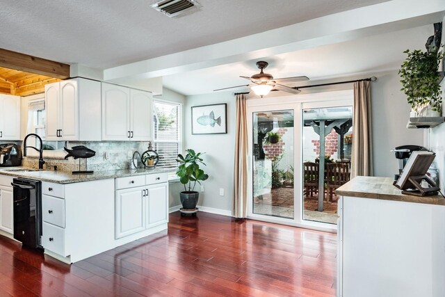 kitchen featuring tasteful backsplash, visible vents, beverage cooler, dark wood-style floors, and a sink