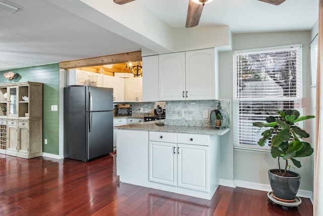 kitchen with visible vents, a wealth of natural light, freestanding refrigerator, white cabinets, and dark wood-style flooring