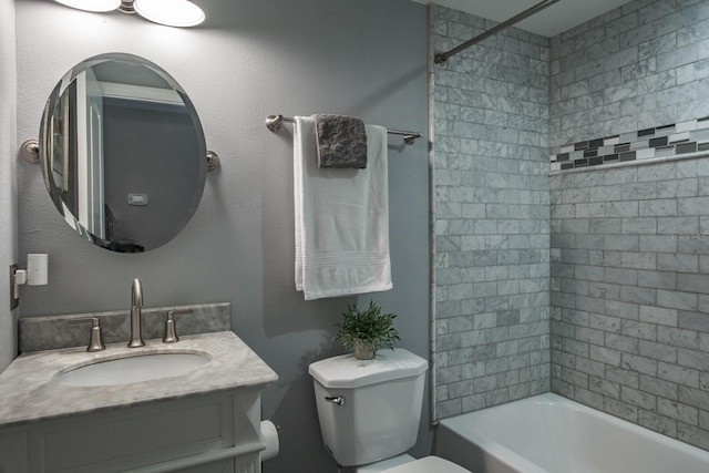 bathroom featuring vanity, shower / bathing tub combination, and toilet