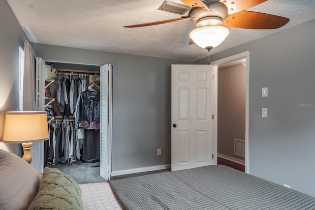 carpeted bedroom with baseboards, visible vents, a closet, and a textured ceiling