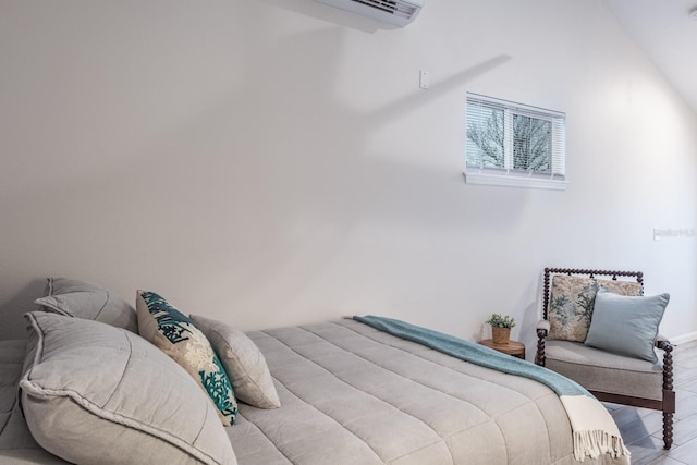 bedroom with vaulted ceiling and wood finished floors