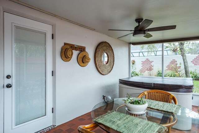 sunroom / solarium featuring ceiling fan