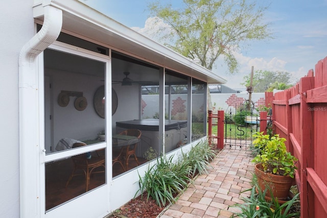 view of home's exterior with fence private yard and a sunroom