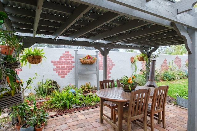 view of patio with outdoor dining space and fence