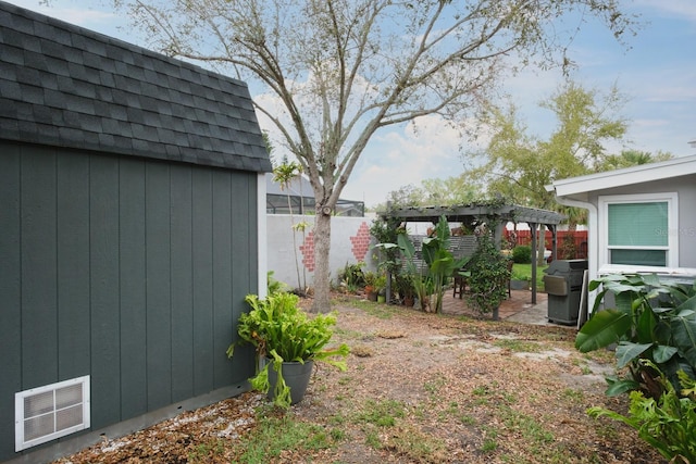 view of yard with visible vents, fence, an outdoor structure, a patio area, and a pergola