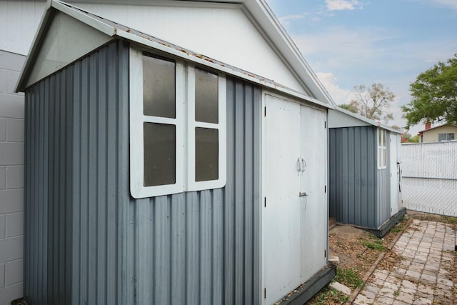 view of shed with fence