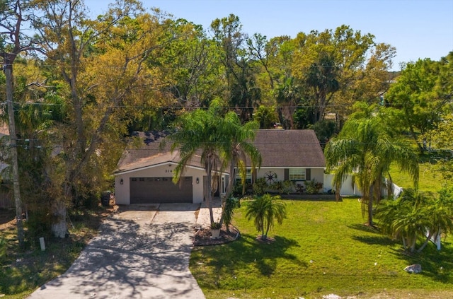 view of front facade featuring a front lawn, a garage, driveway, and stucco siding