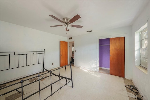 bedroom featuring tile patterned floors, visible vents, baseboards, and a closet