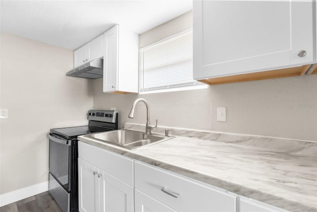 kitchen featuring baseboards, under cabinet range hood, stainless steel electric range, white cabinets, and a sink