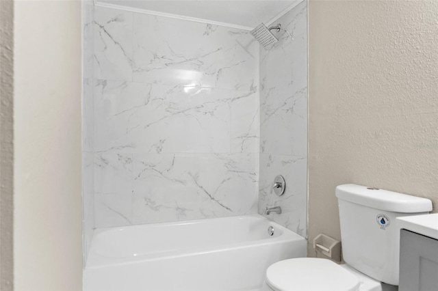 bathroom with vanity, toilet, a textured wall, and bathtub / shower combination