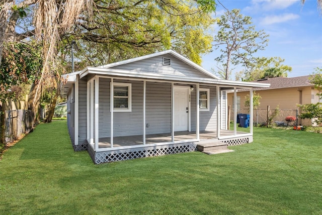 exterior space featuring covered porch, a fenced backyard, and a front yard