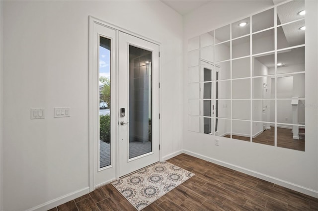 foyer featuring french doors, baseboards, and dark wood-style floors