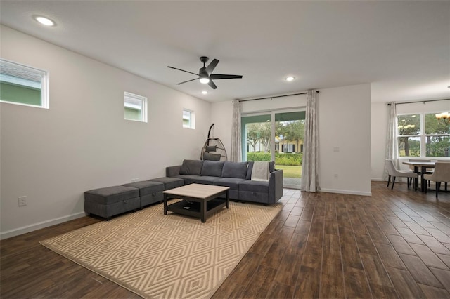 living room with recessed lighting, baseboards, and dark wood-style flooring