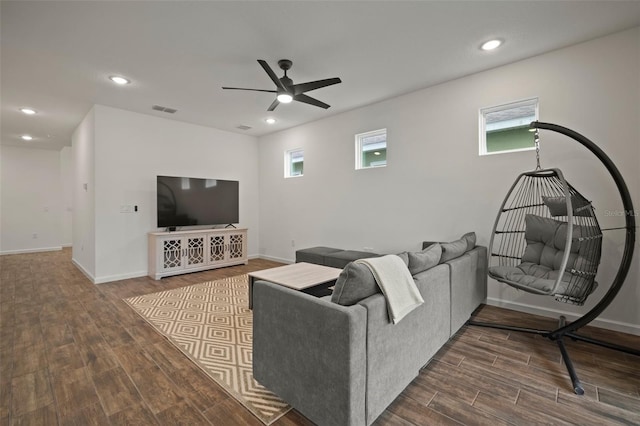 living room with a wealth of natural light, visible vents, wood finished floors, and recessed lighting