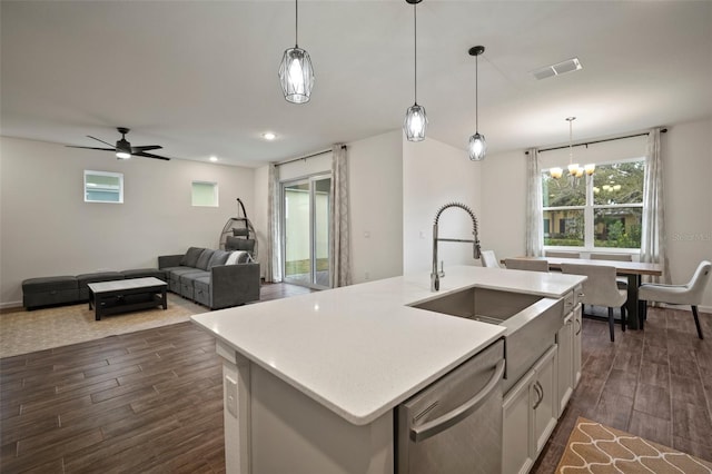 kitchen featuring dark wood-style floors, visible vents, a sink, light countertops, and dishwasher