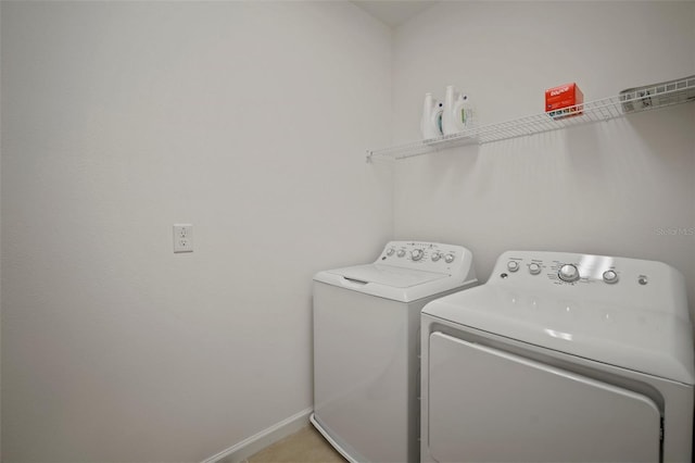 laundry room with baseboards, washing machine and dryer, and laundry area