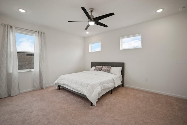 bedroom with multiple windows, baseboards, and carpet floors