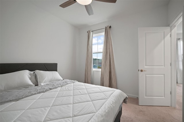 carpeted bedroom with baseboards and a ceiling fan