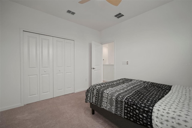 bedroom featuring a closet, visible vents, a ceiling fan, and carpet