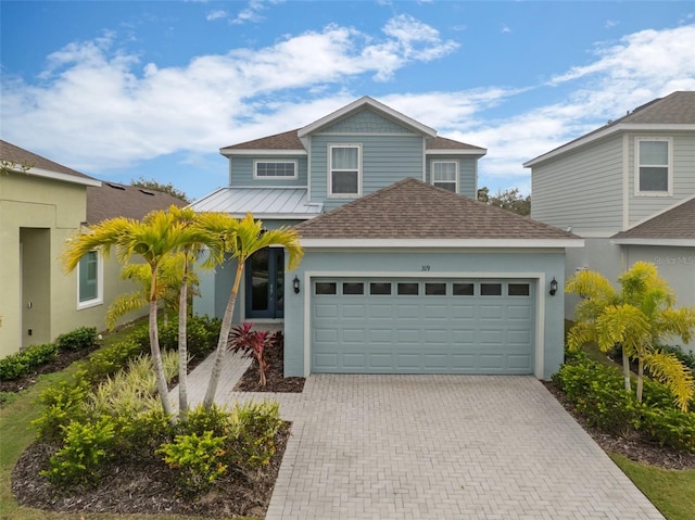 view of front of home featuring a garage, decorative driveway, and a shingled roof