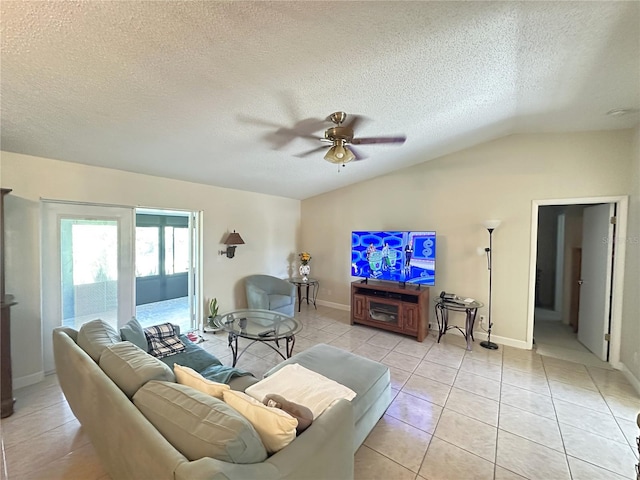 living area featuring baseboards, light tile patterned flooring, ceiling fan, vaulted ceiling, and a textured ceiling