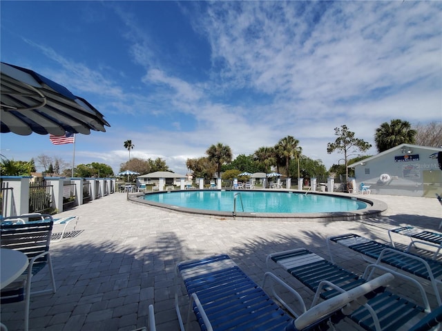 pool featuring a patio and fence