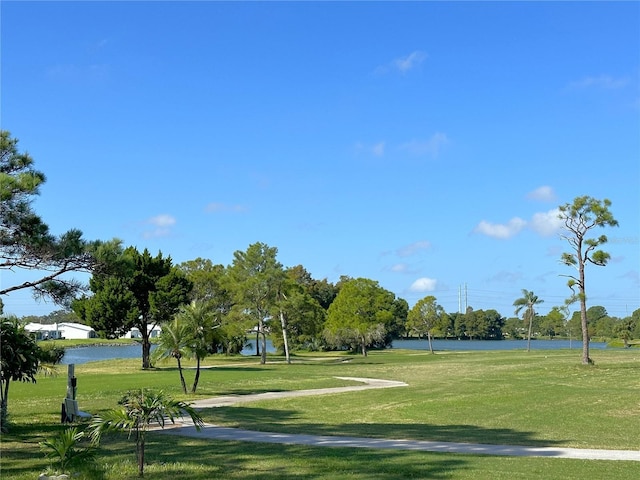 surrounding community featuring a yard and a water view