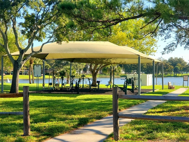 view of home's community with a lawn and a water view