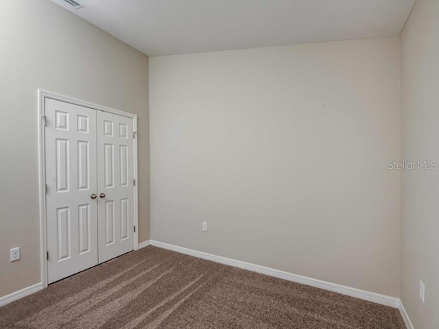 interior space featuring baseboards and carpet