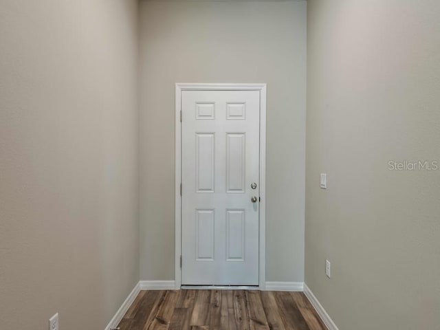 doorway to outside featuring dark wood-style floors and baseboards