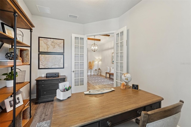 office area with wood finished floors, french doors, visible vents, and a chandelier