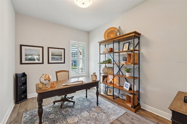 office area featuring baseboards and wood finished floors