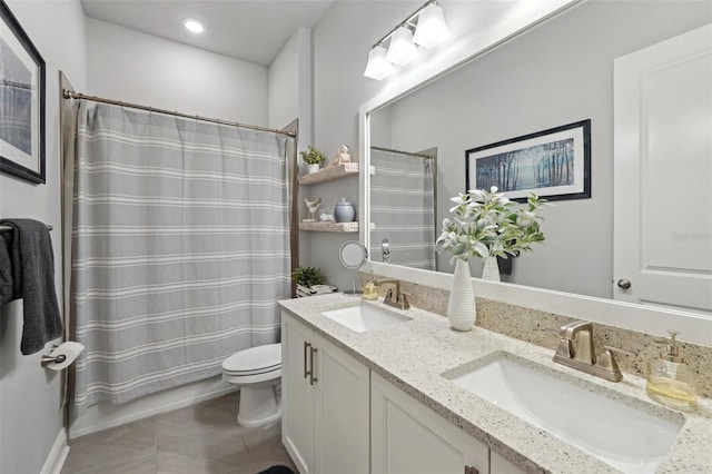 full bathroom featuring tile patterned flooring, double vanity, toilet, and a sink