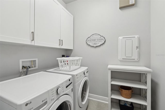 laundry room with washing machine and clothes dryer, cabinet space, and baseboards