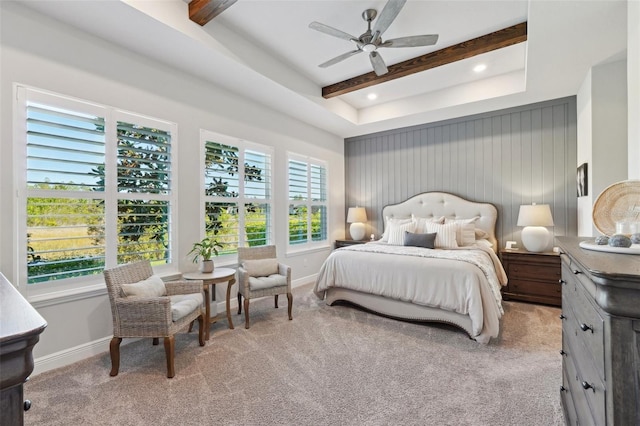 carpeted bedroom with beamed ceiling, multiple windows, and baseboards