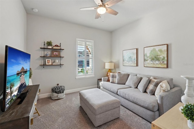 carpeted living room with baseboards and a ceiling fan