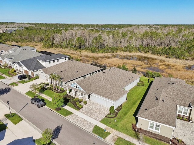 birds eye view of property featuring a view of trees and a residential view