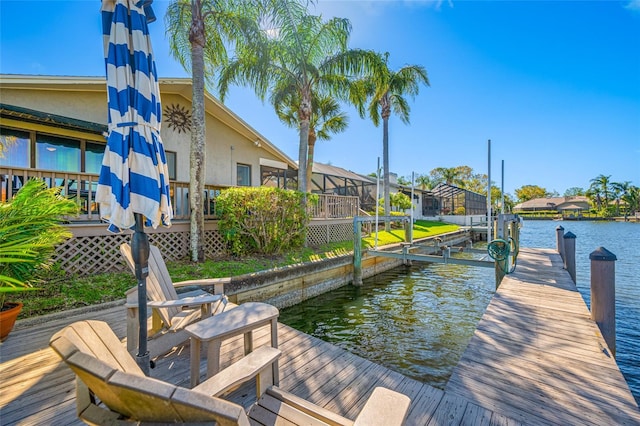 dock area featuring glass enclosure, a water view, and boat lift