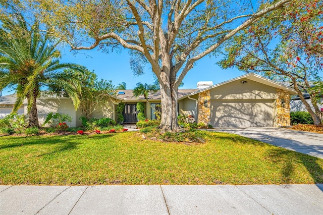 view of front of home featuring concrete driveway, a garage, a front yard, and stucco siding