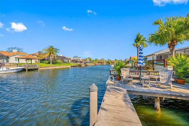 view of dock featuring a residential view and a water view