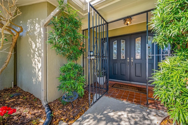 entrance to property featuring stucco siding