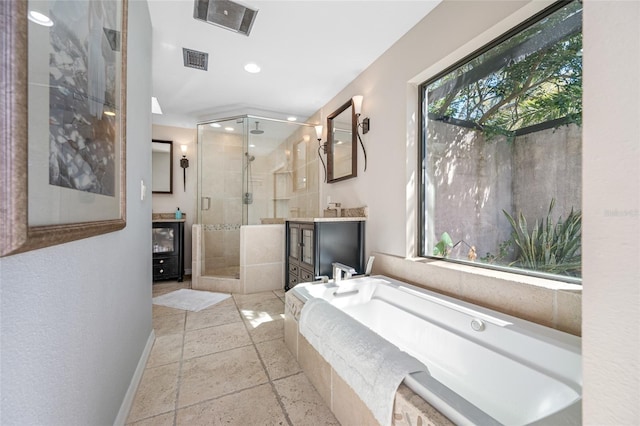 full bath with visible vents, baseboards, a garden tub, a stall shower, and vanity