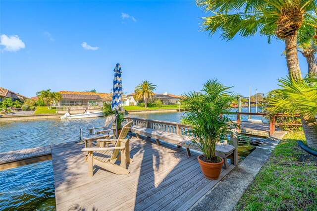 view of dock featuring a residential view and a water view