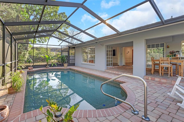 outdoor pool with a patio area and a lanai