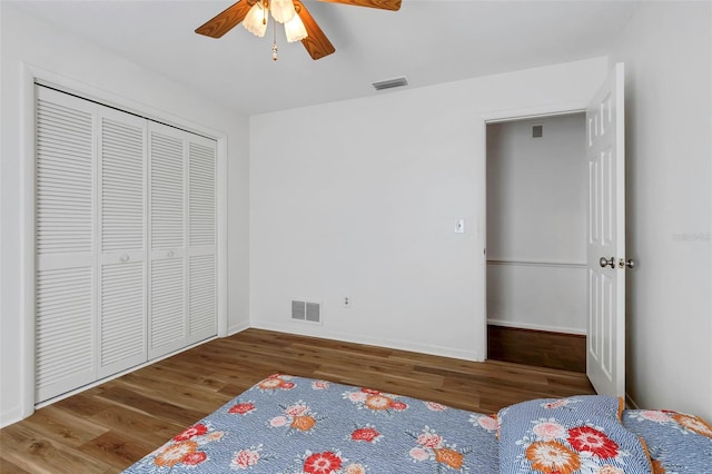 unfurnished bedroom with visible vents, baseboards, and wood finished floors