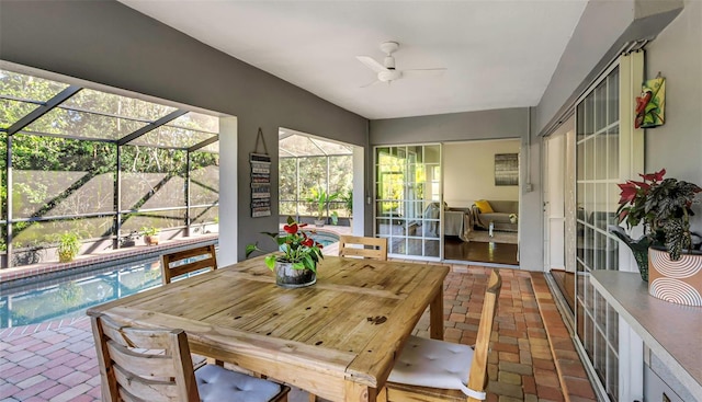 sunroom featuring a ceiling fan