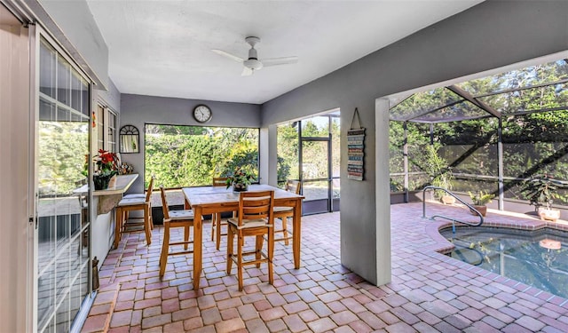 sunroom featuring a ceiling fan