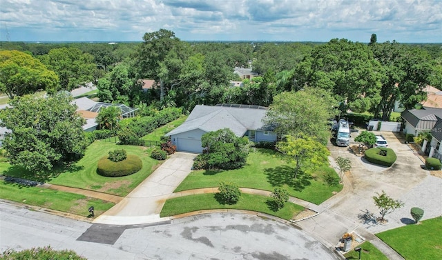 drone / aerial view featuring a view of trees