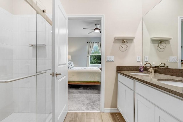 ensuite bathroom featuring a sink, connected bathroom, and a shower stall