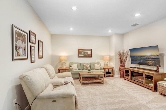 living area with recessed lighting, visible vents, and light carpet